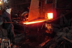 metal-worker-moving-hot-metal