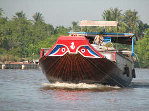 Boat cruising the Mekong Delta